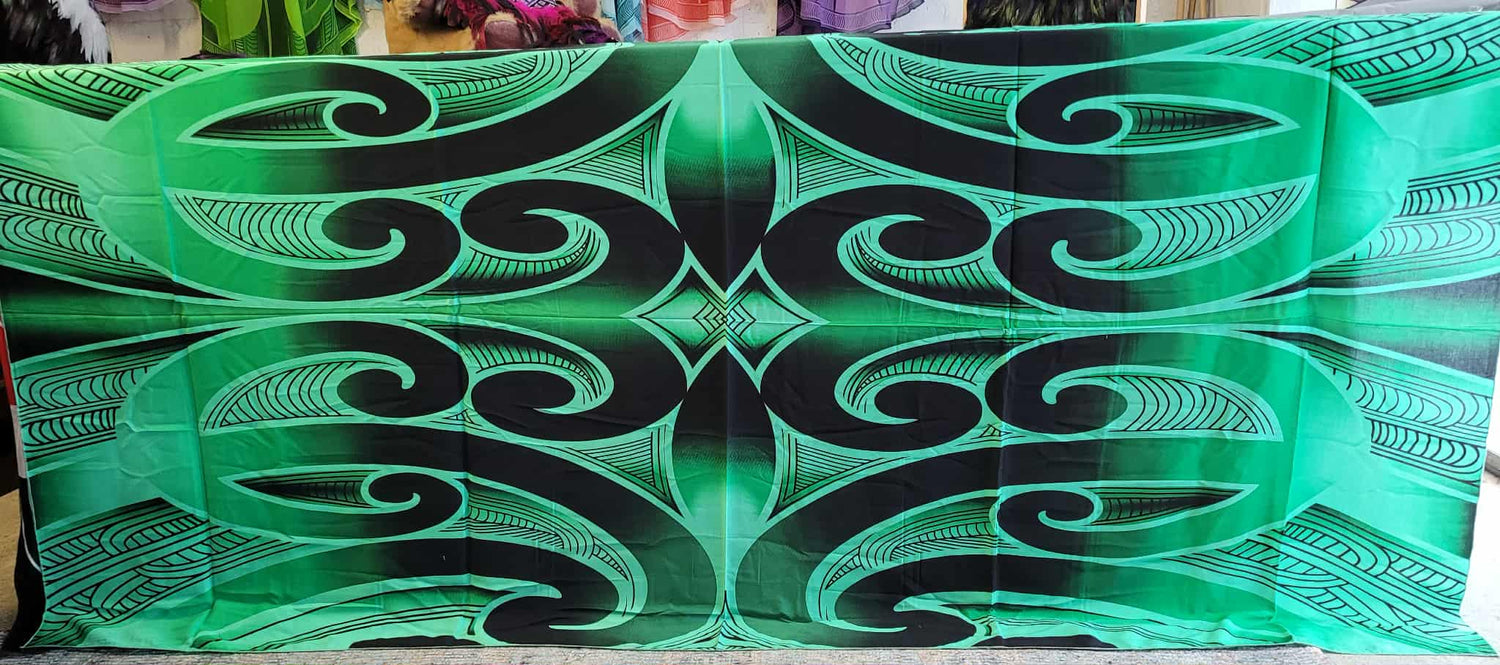 Green and black decorative patterned tablecloth with intricate designs.