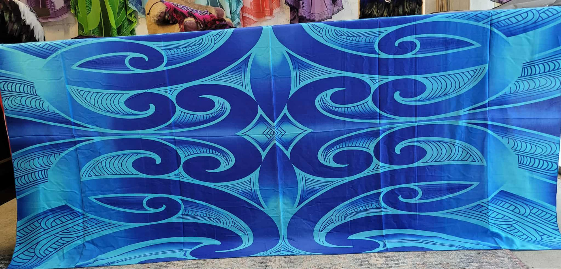 Blue patterned fabric with wave design on a plain background